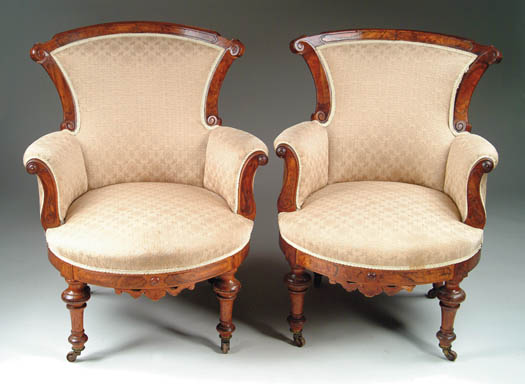 Appraisal: PAIR OF VICTORIAN WALNUT UPHOLSTERED ARMCHAIRS The curved crest with