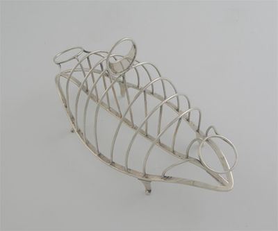 Appraisal: A George III wirework toast rack on an undulating navette