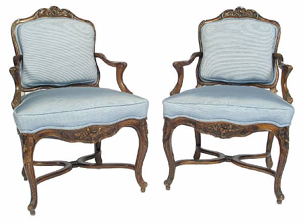 Appraisal: A pair of Louis XIV style carved beechwood fauteuils height