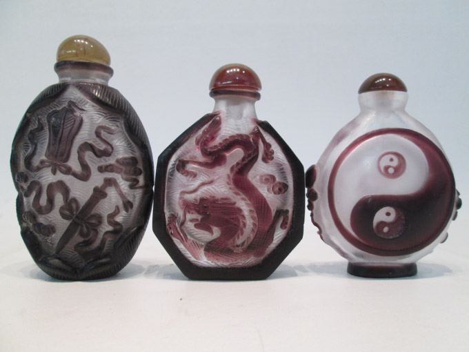 Appraisal: THREE CHINESE GLASS SNUFF BOTTLES each purple cut-to-clear glass snuff