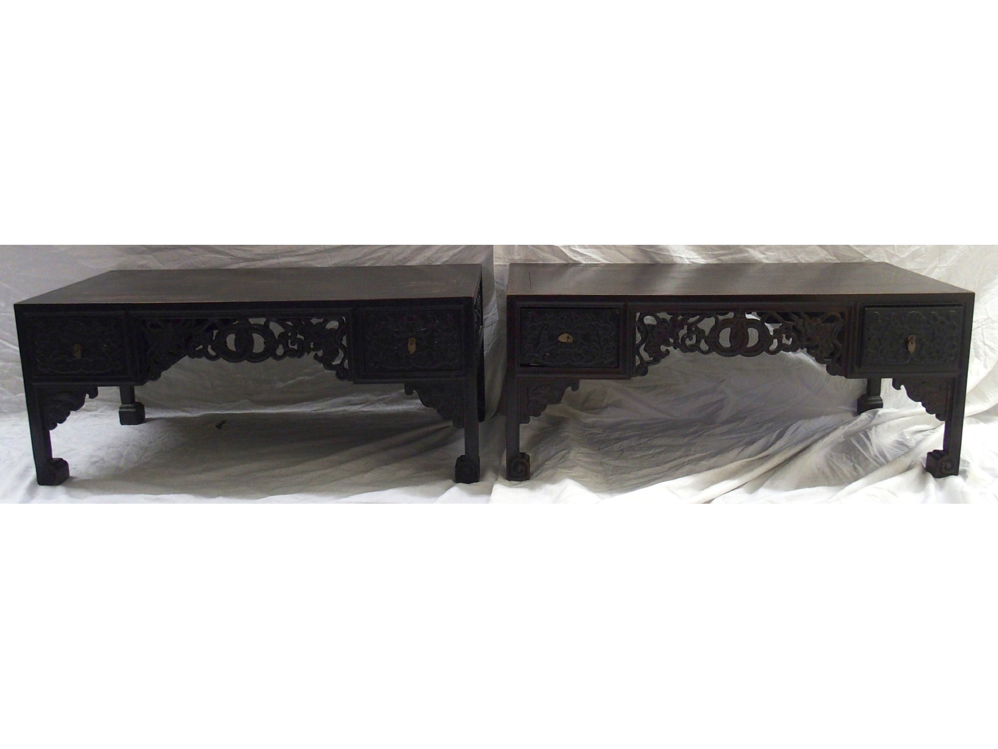 Appraisal: A pair of Chinese hardwood rectangular low tablescarved with a