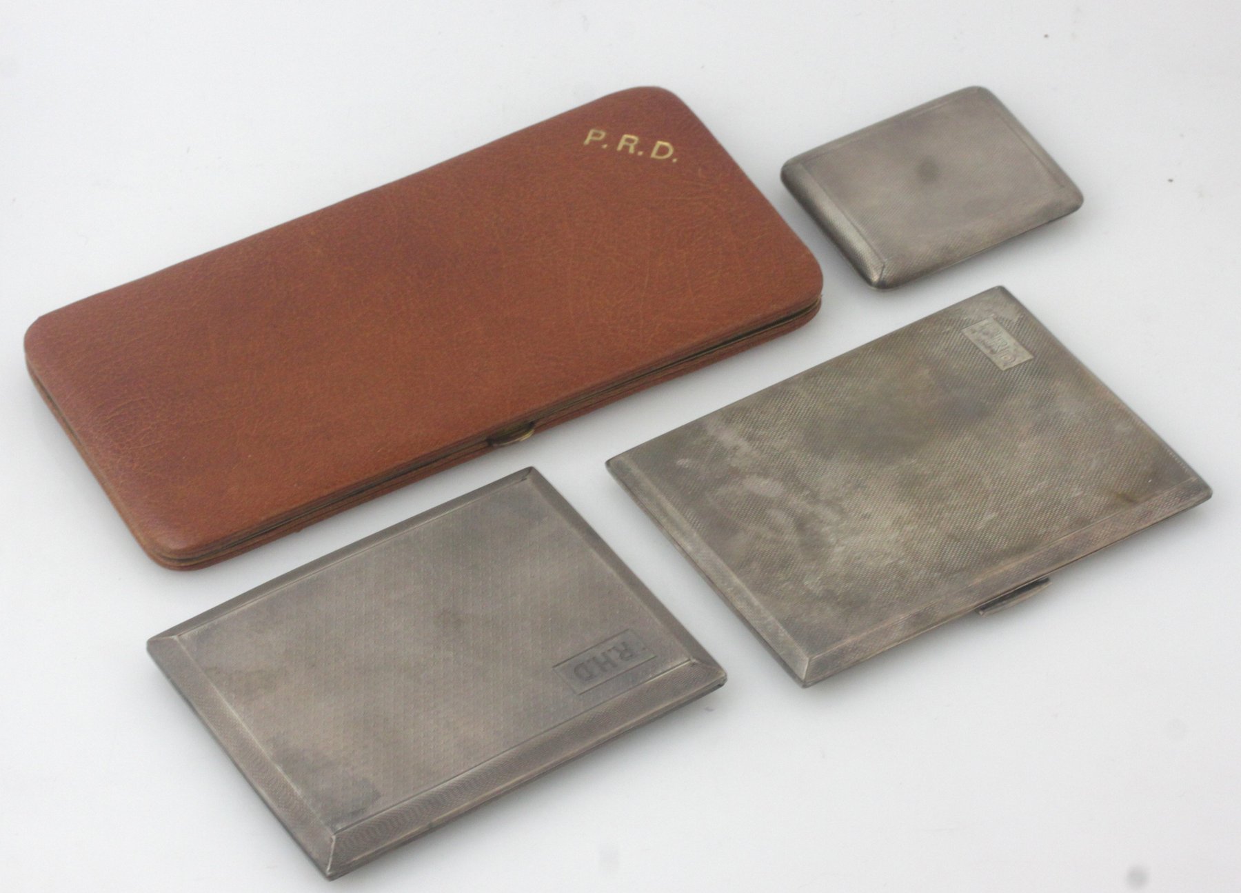 Appraisal: A silver cigarette case Bimingham with engine turning and initialled