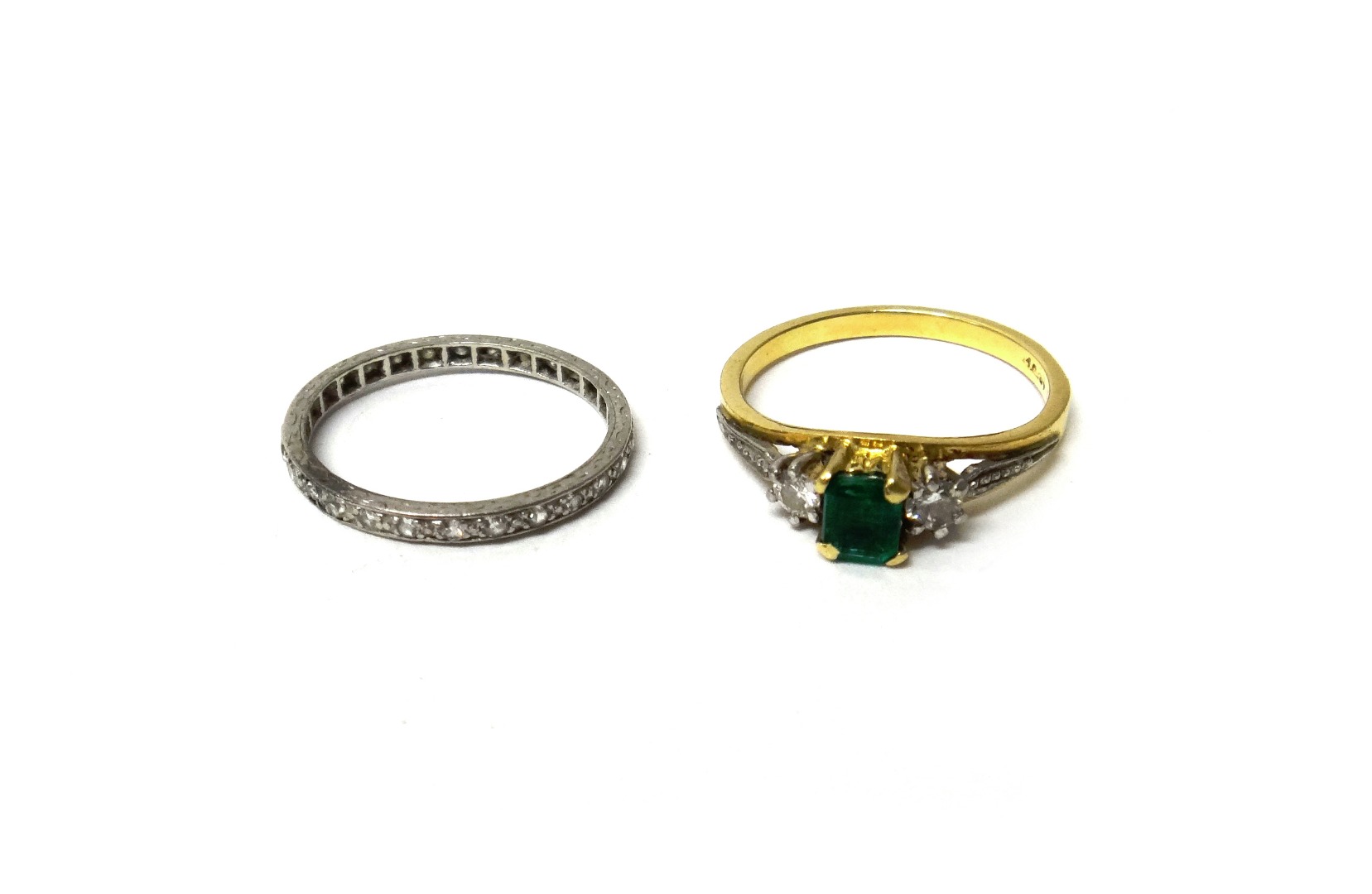 Appraisal: A gold emerald and diamond set three stone ring claw