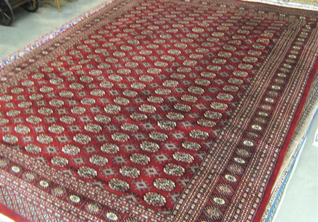 Appraisal: RED FIELD BOKHARA CARPET ' x '