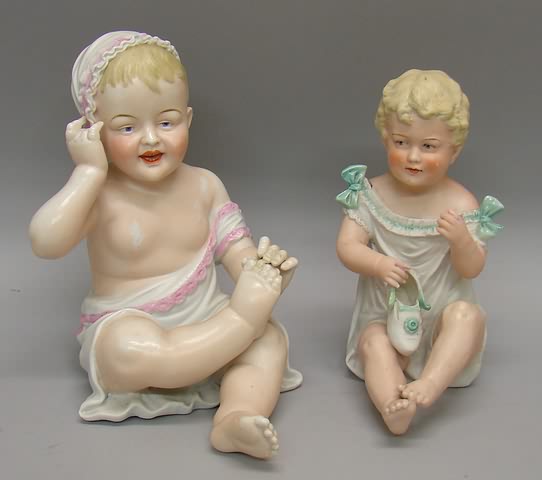 Appraisal: Pair of German bisque sitting baby figurines Unmarked baby in