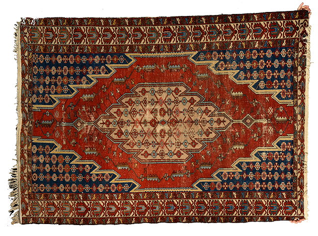 Appraisal: AN OLD MAZLAGHAN BRICK GROUND RUG with central stylised design