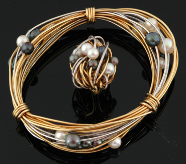 Appraisal: A cultured pearl bangle and ring The abstract wire setting