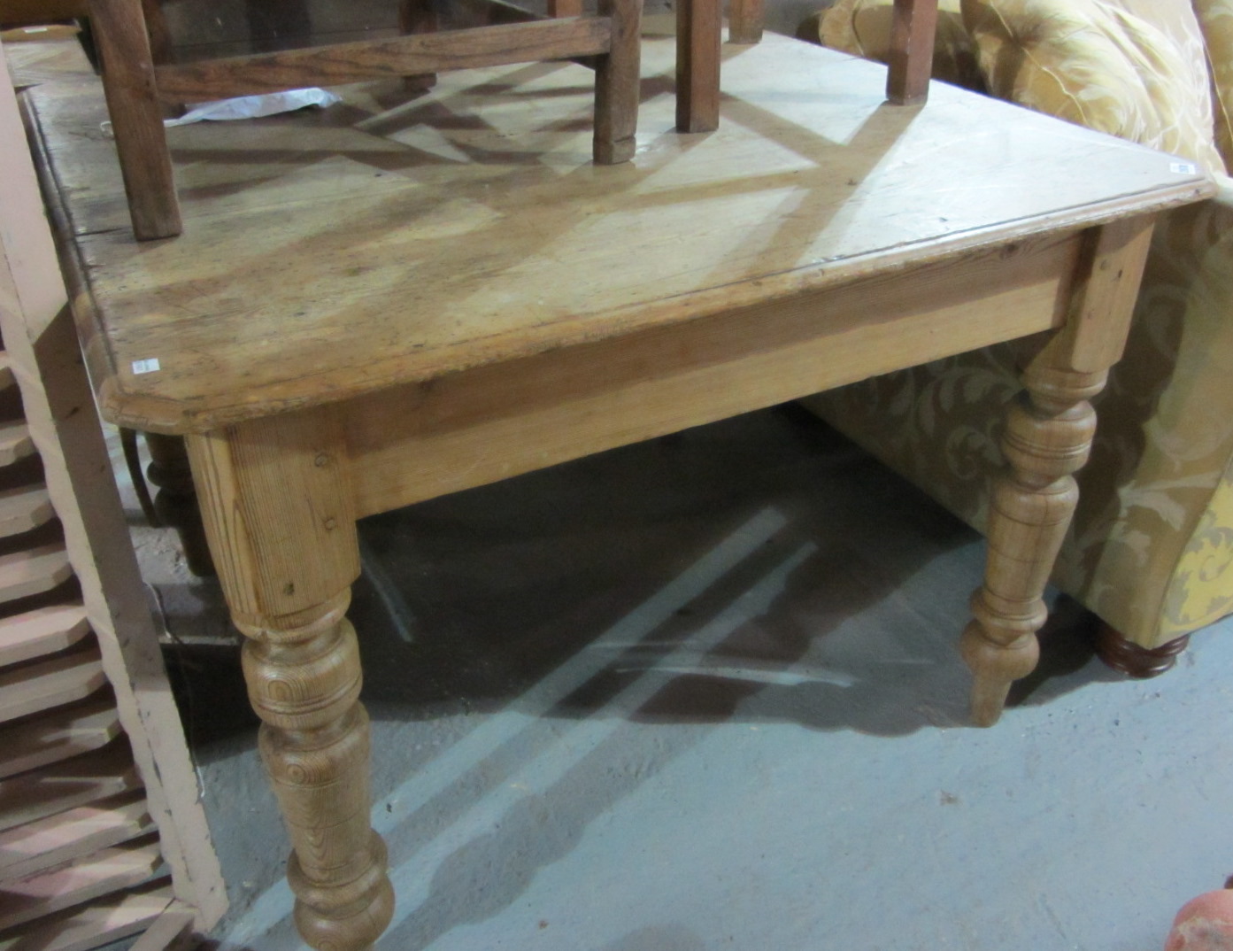 Appraisal: A square pine kitchen table with chamfered corners