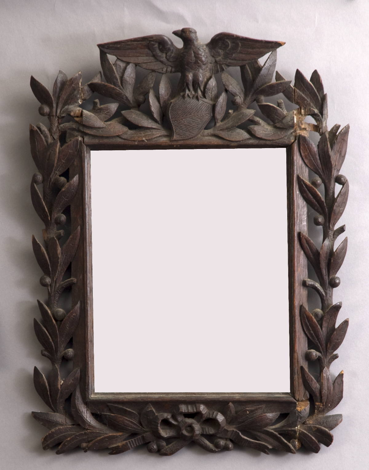 Appraisal: AMERICAN SAILOR CARVED WALNUT MIRROR WITH STYLIZED EAGLE SHIELD AND