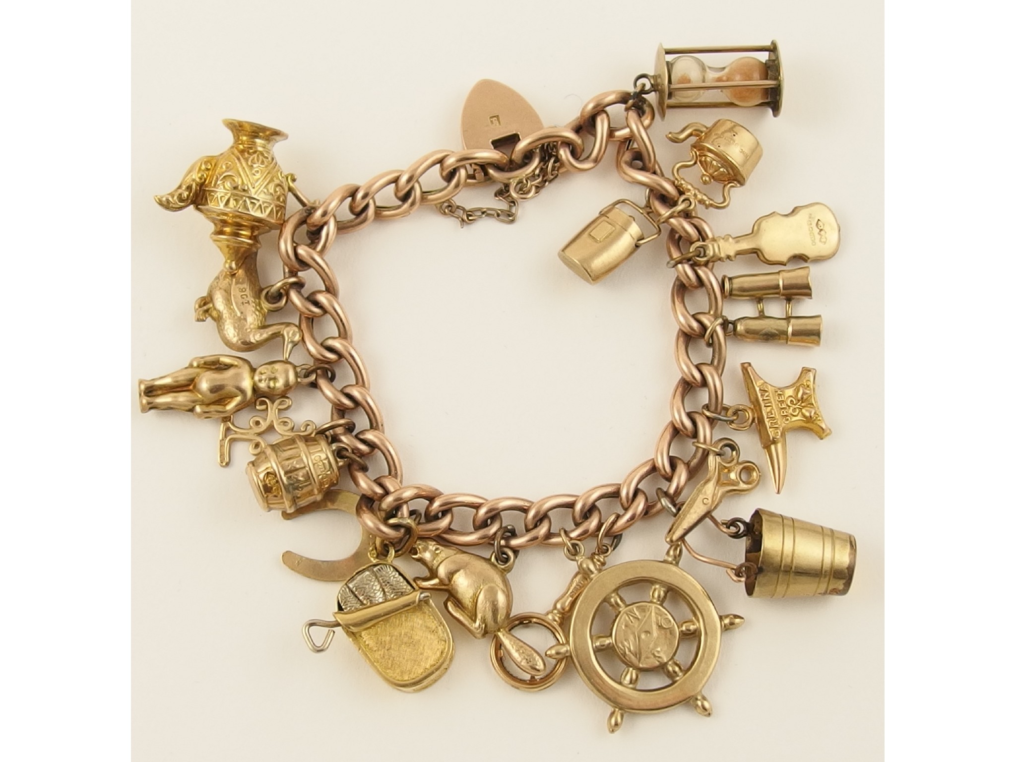 Appraisal: A ct charm bracelet with eighteen attached ct and yellow