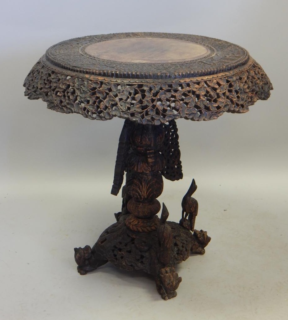 Appraisal: A thC Burmese carved teak occasional table the circular top