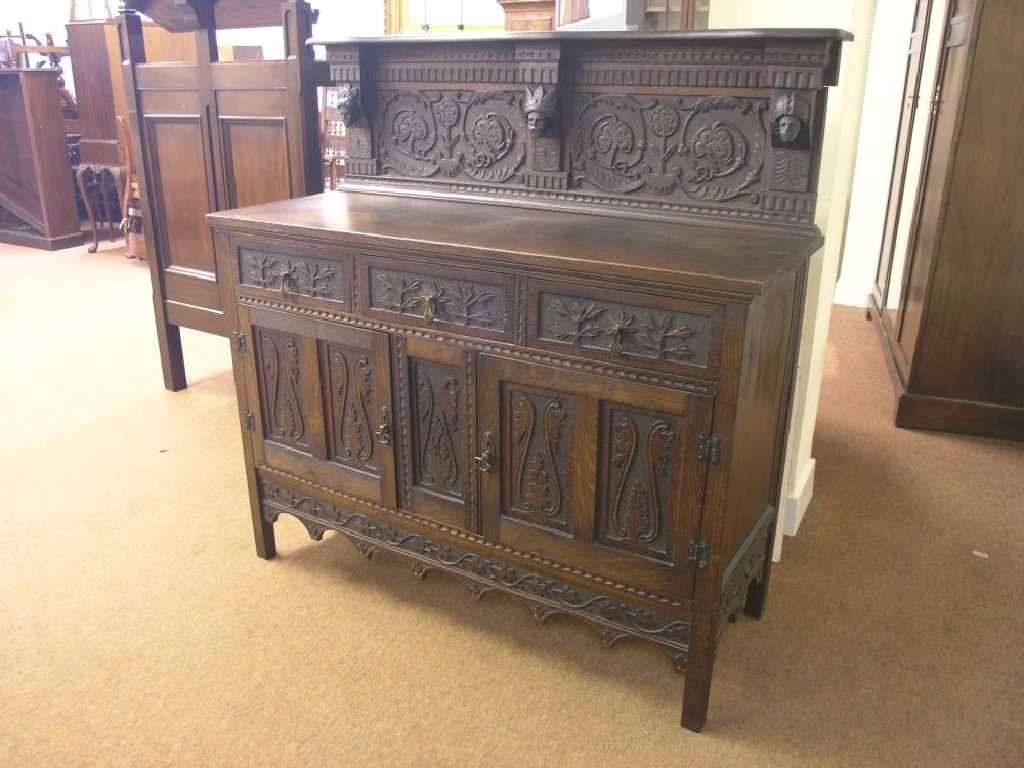 Appraisal: A late th century dark carved oak sideboard raised back