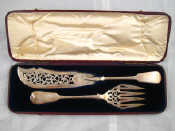 Appraisal: A pair of Victorian silver pierced fish servers in original