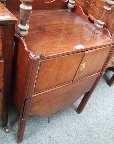 Appraisal: A George III mahogany commode the shaped galleried top with