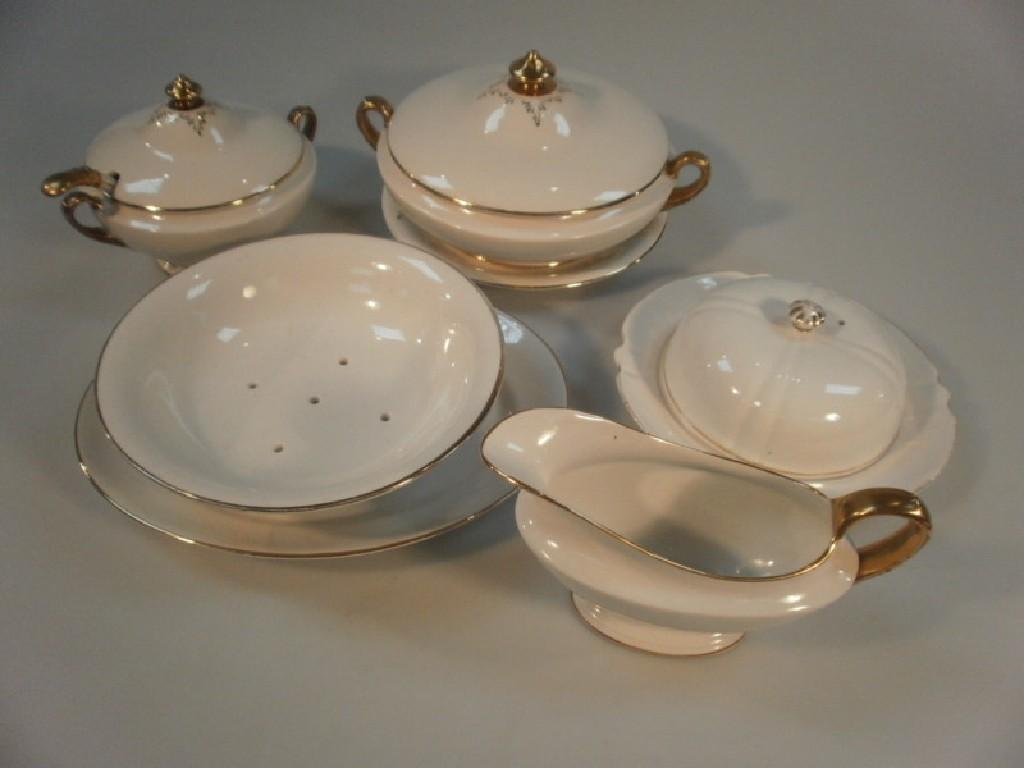 Appraisal: A Devon ware pottery white ground part dinner service by