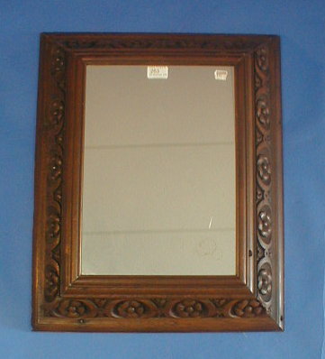 Appraisal: A carved oak rectangular cushion mirror