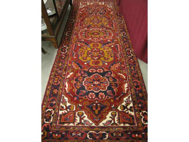 Appraisal: Heriz Persian Handmade Rug stylized floral medallions deep rich colors