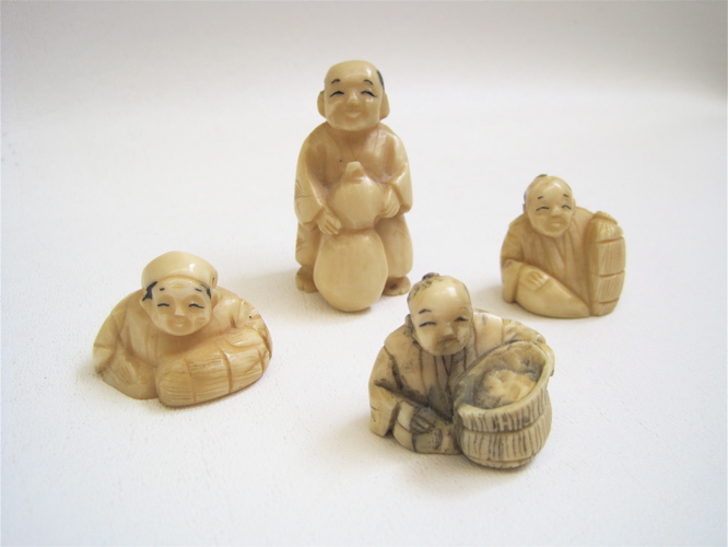 Appraisal: FOUR IVORY CARVED NETSUKE man standing holding vase three depicting