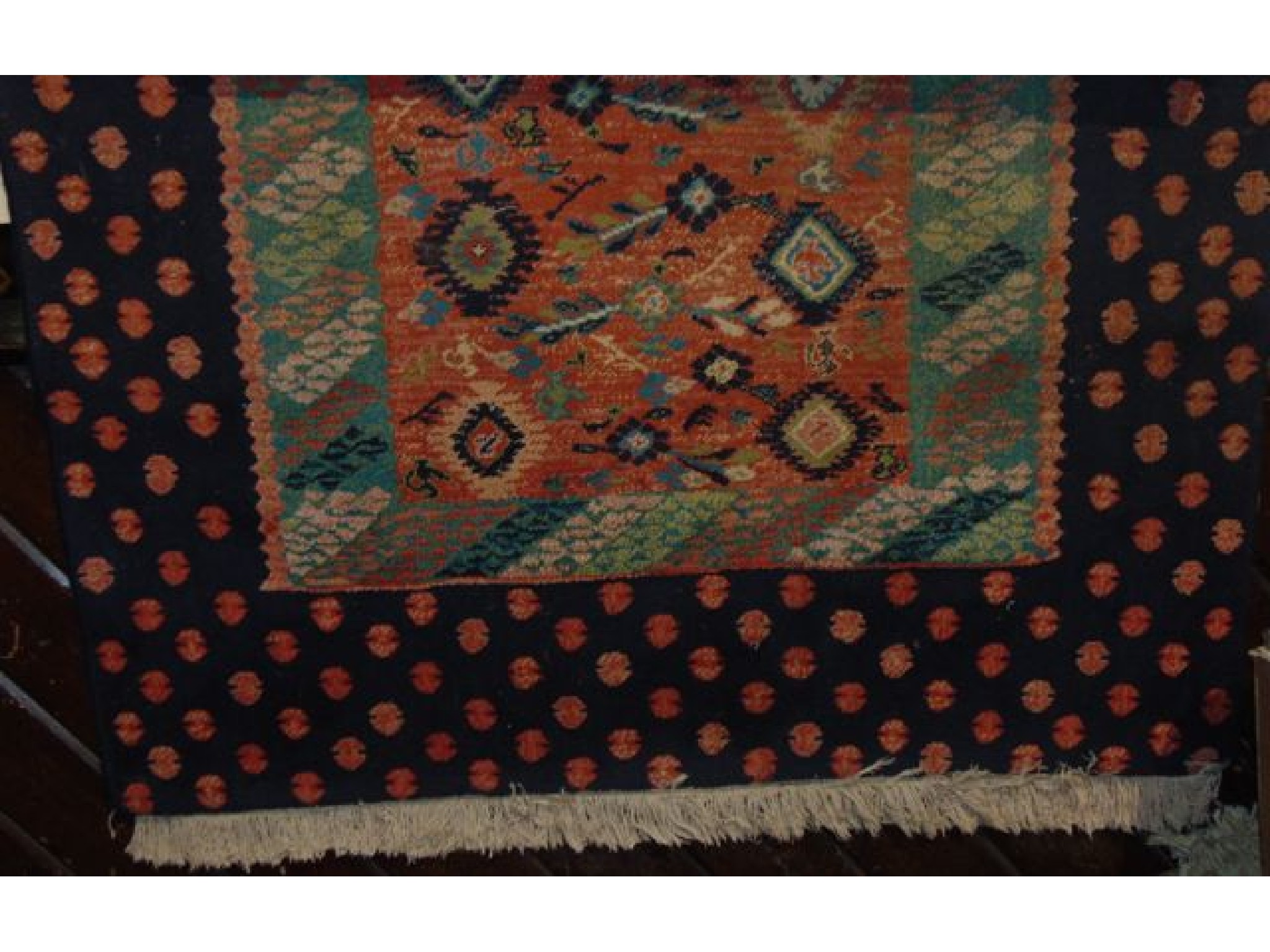 Appraisal: An eastern wool rug with multi coloured central panel set