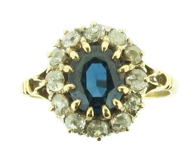 Appraisal: A sapphire and diamond cluster ring The oval shaped sapphire