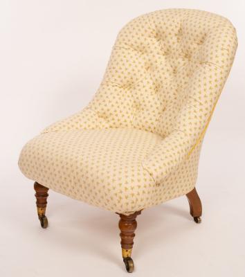 Appraisal: A Victorian upholstered chair with deep buttoned back on turned