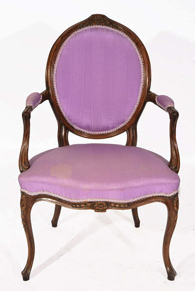 Appraisal: A LOUIS XVI STYLE CARVED WALNUT OPEN ARMCHAIR with oval