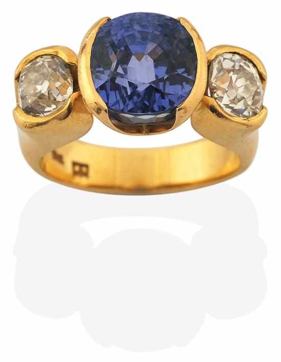 Appraisal: A THREE STONE SAPPHIRE AND DIAMOND RING Centrally set with