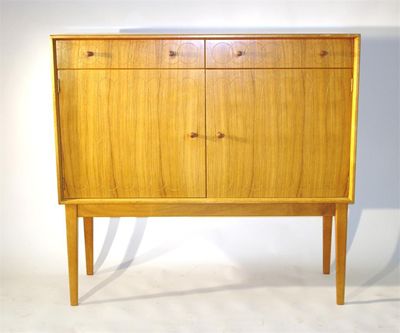 Appraisal: A Gordon Russell bleached mahogany and rosewood sideboard with carved