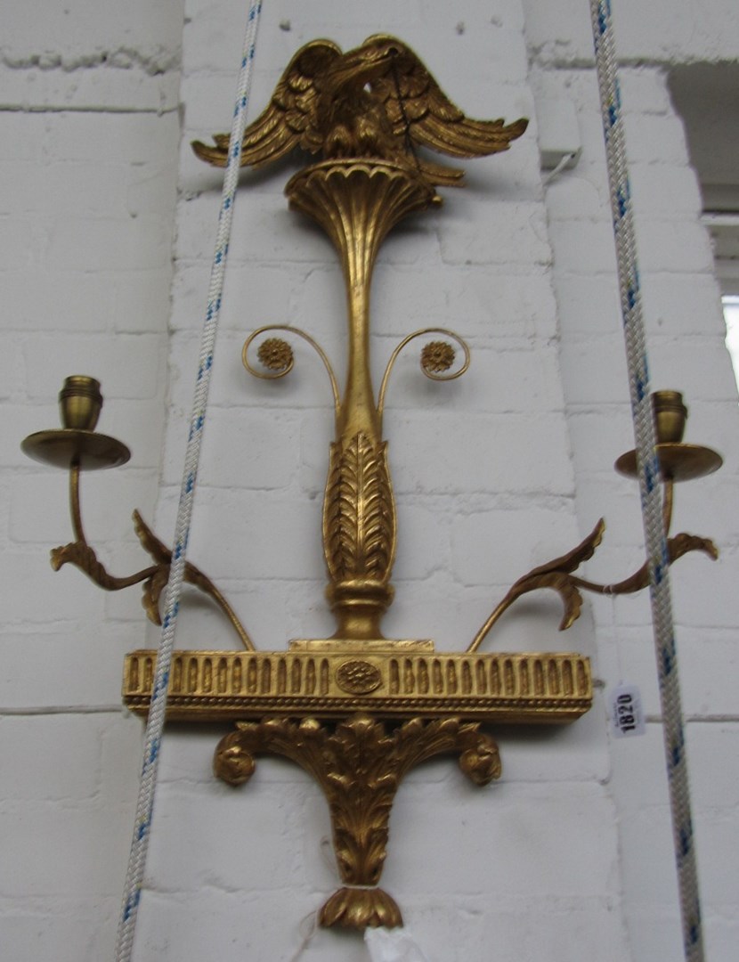 Appraisal: A pair of Regency style giltwood two branch wall lights