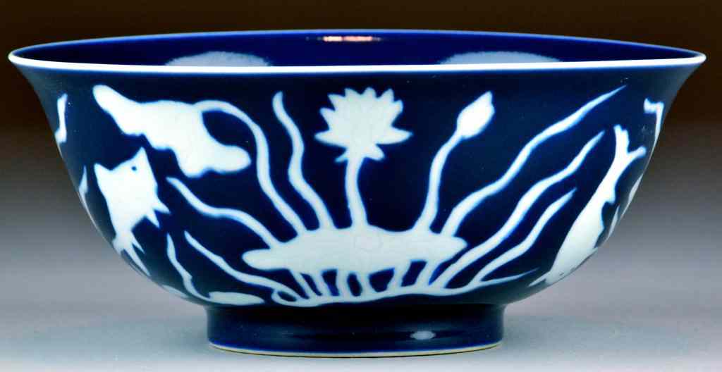 Appraisal: Chinese Large Blue Bowl with White FlowersDark blue porcelain bowl