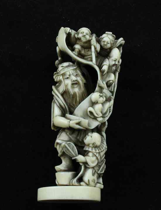 Appraisal: A Meiji period ivory netsuke carved as Shoki holding a