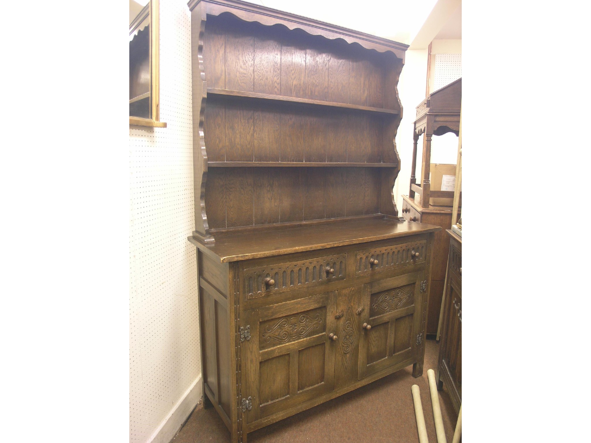 Appraisal: A solid dark oak Welsh dresser twin-shelf plate rack above