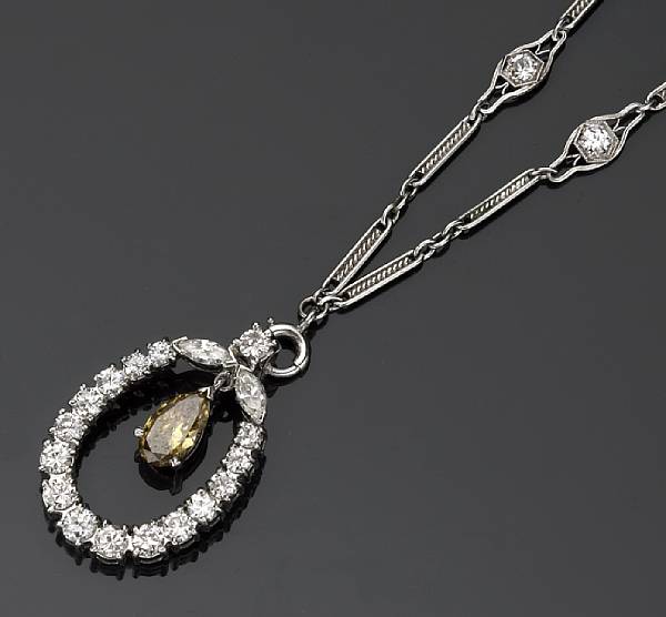 Appraisal: A diamond and colored diamond pendant and chain suspending a