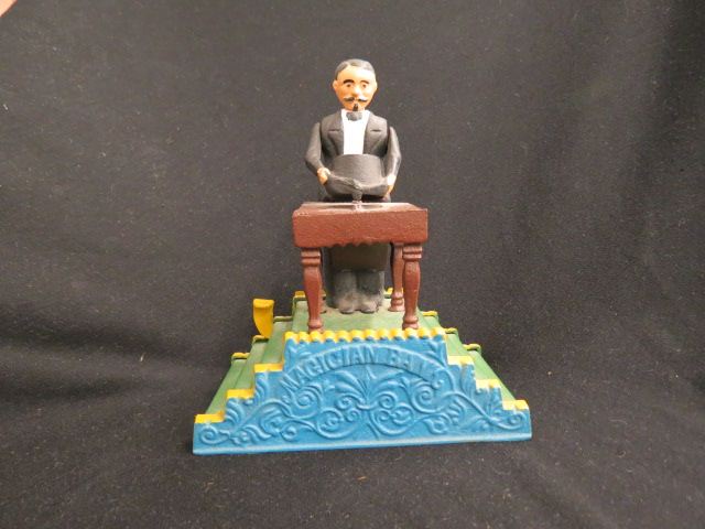 Appraisal: Cast Iron Mechanical Bank Magician Book of Knowledge Series excellent