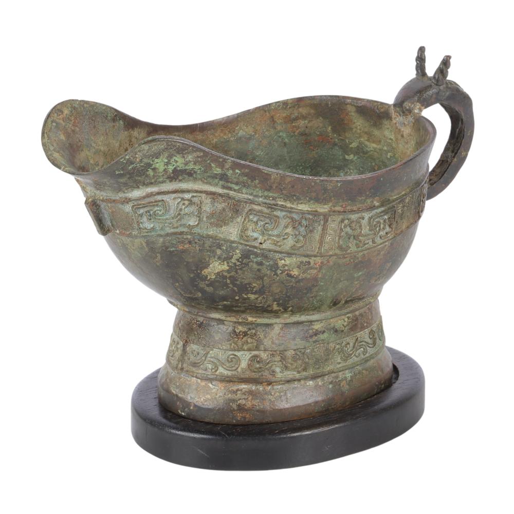 Appraisal: CHINESE ARCHAIC CEREMONIAL BRONZE YI POURING VESSEL MANNER OF WARRING