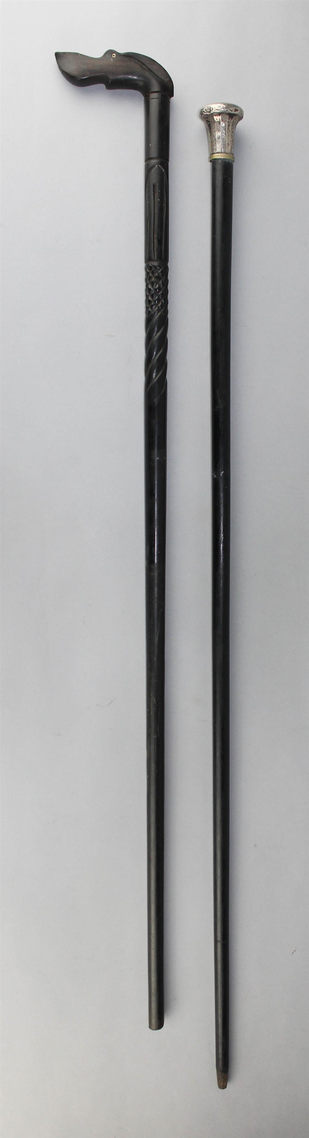 Appraisal: TWO VINTAGE WALKING STICKS one with a sculptural handle in