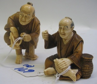 Appraisal: TWO JAPANESE IVORY AND WOOD HAND CARVED FIGURES the first