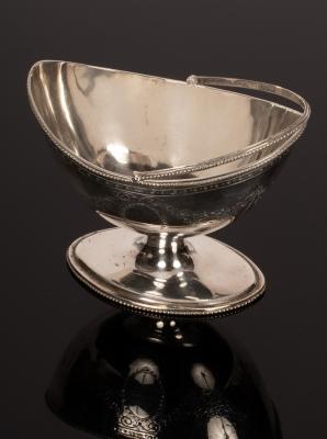 Appraisal: A George III swing handled silver sugar basket London with