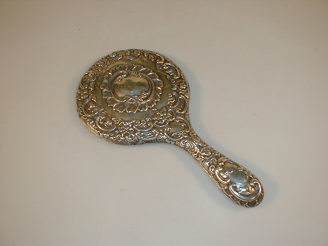 Appraisal: An Edward VII silver backed hand mirror repouss with rococo