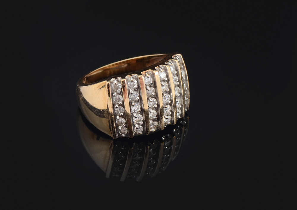 Appraisal: DIAMOND COCKTAIL RING K yellow gold ring contains round brilliant