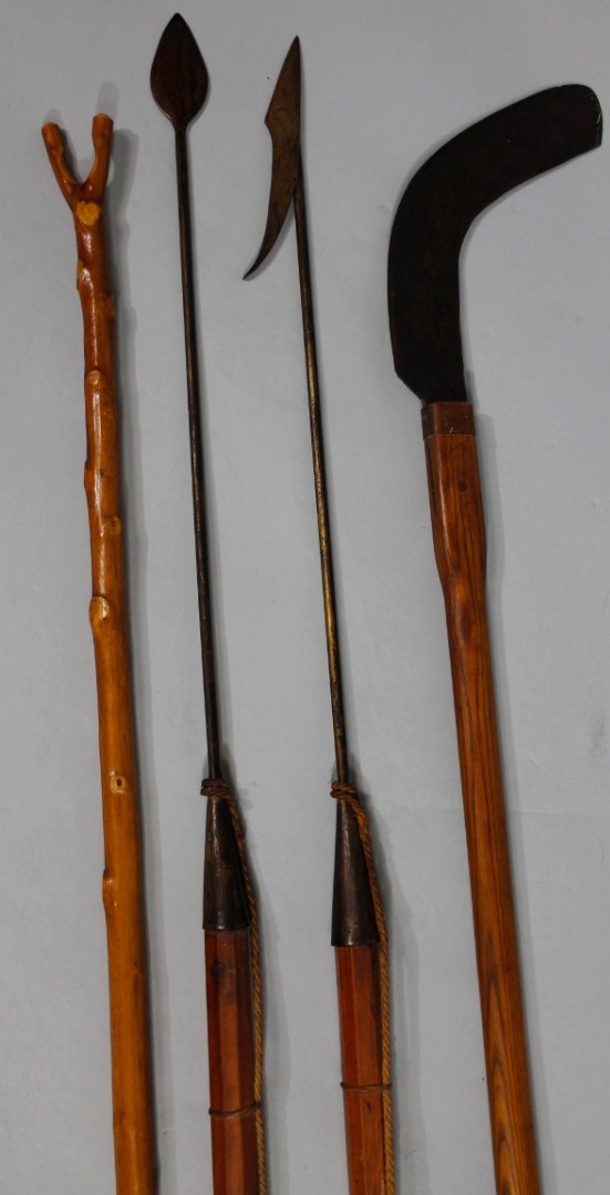 Appraisal: Two shaped harpoons with wooden handles and metal arrow ends