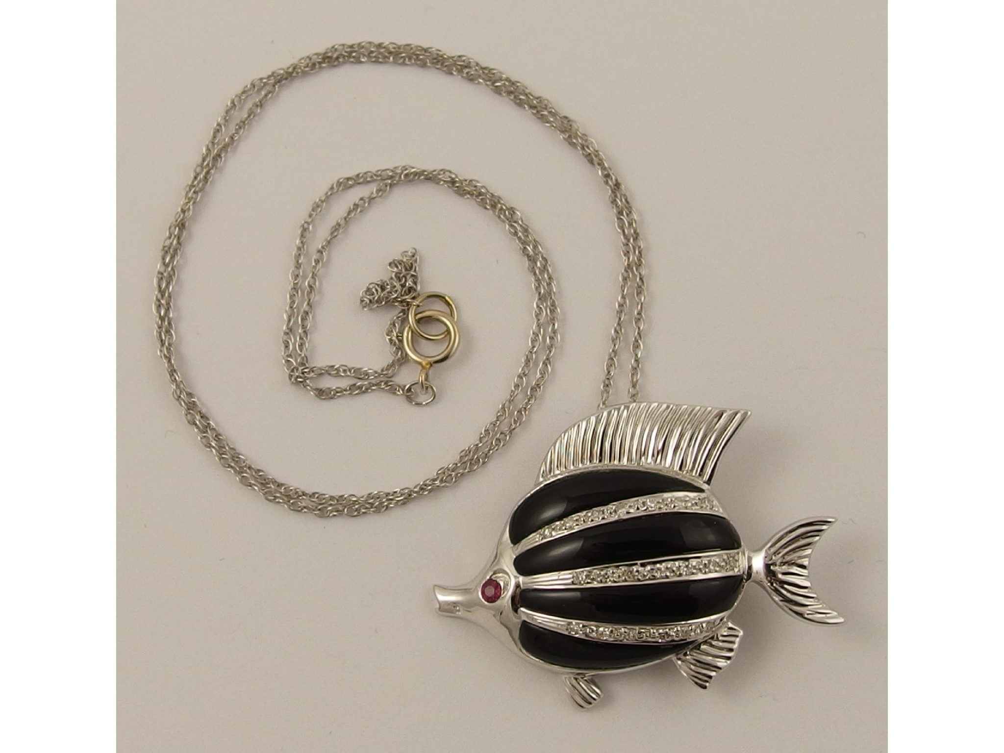 Appraisal: An ct onyx diamond and ruby fish pendant brooch with