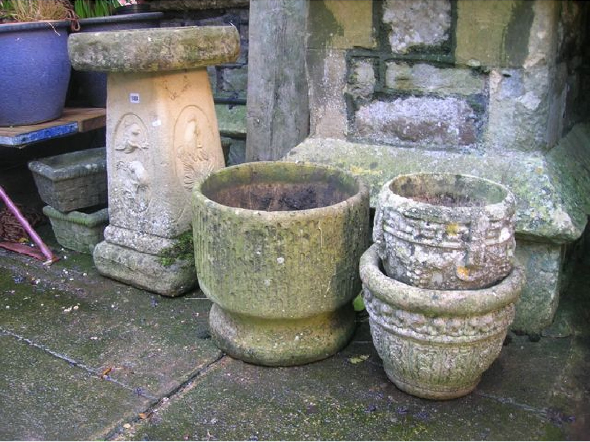 Appraisal: A weathered cast composition stone two sectional bird bath the