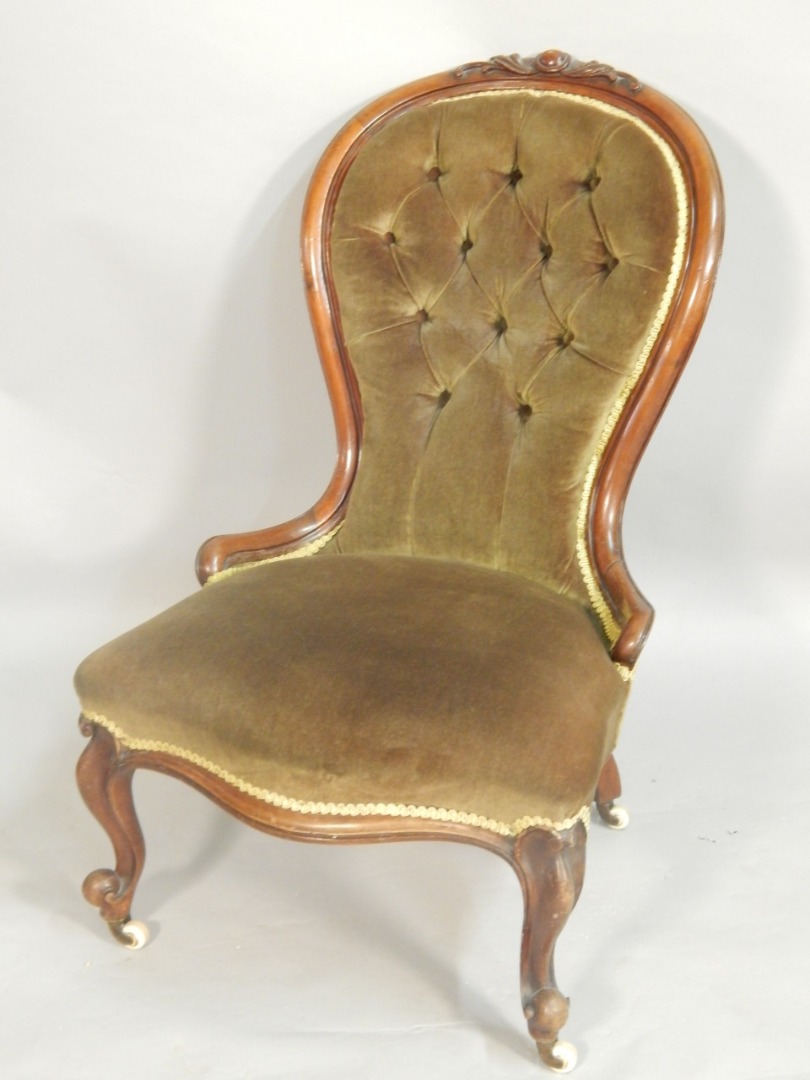 Appraisal: A Victorian mahogany nursing chair with a button back seat