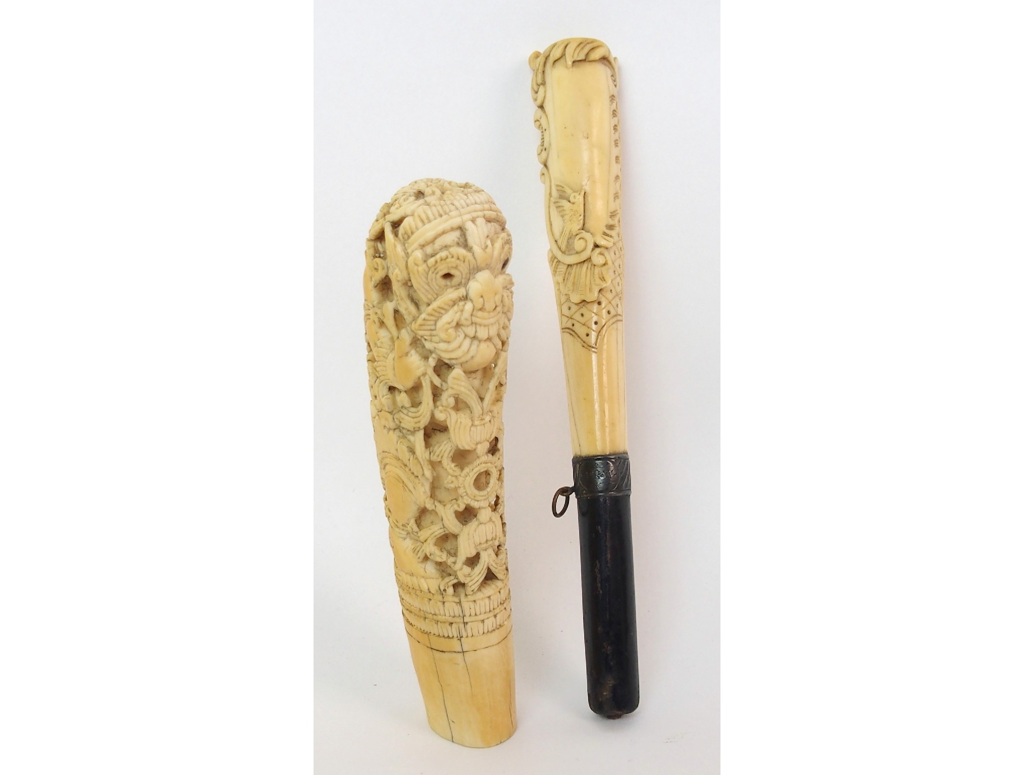 Appraisal: An Indian ivory handlecarved with a mythical god amongst scrolling