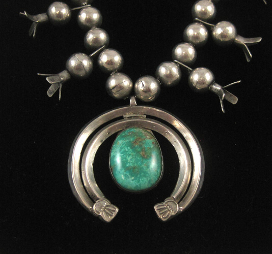 Appraisal: NAVAJO TURQUOISE AND SILVER SQUASH BLOSSOM NECKLACE having central stone