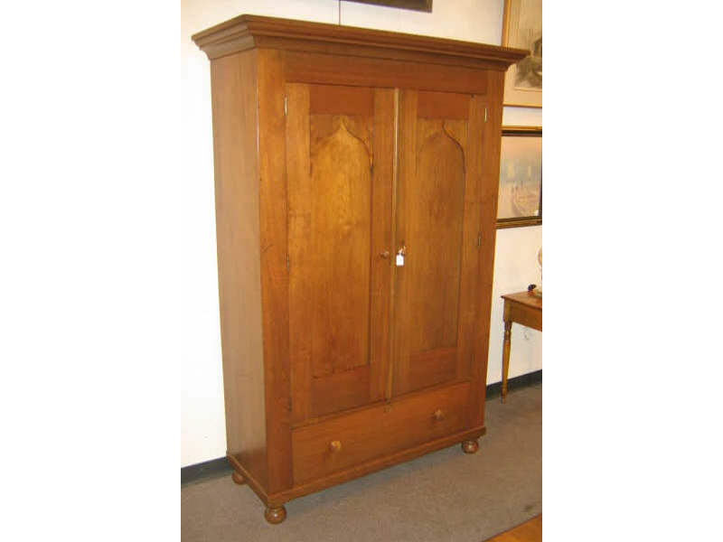 Appraisal: AMERICAN TH CENTURY WALNUT WARDROBE With an overhanging step molded