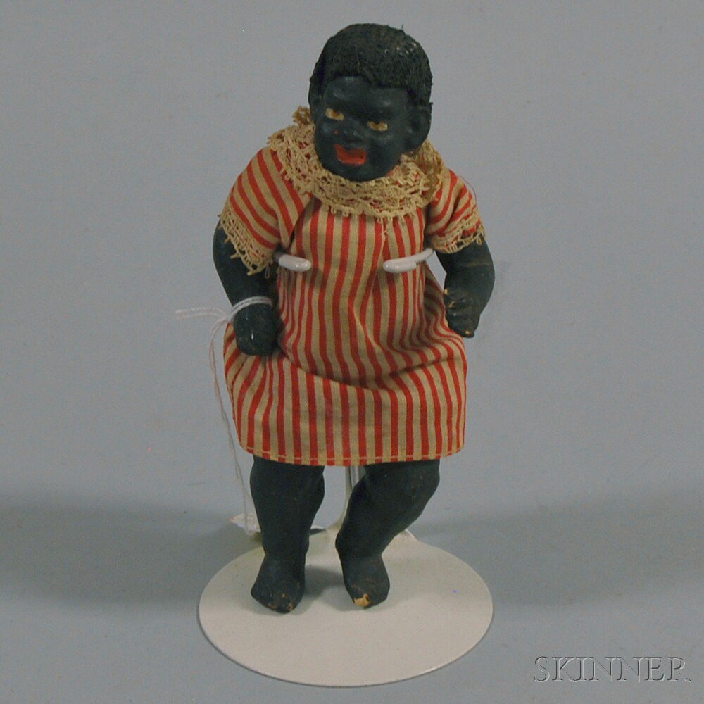 Appraisal: Small Black Painted Composition Doll with all-composition body and red