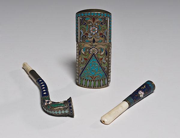 Appraisal: THREE ENAMELED SMOKING ARTICLES late th century Includes two cigarette