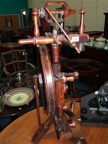 Appraisal: An elm and fruitwood spinning wheel high